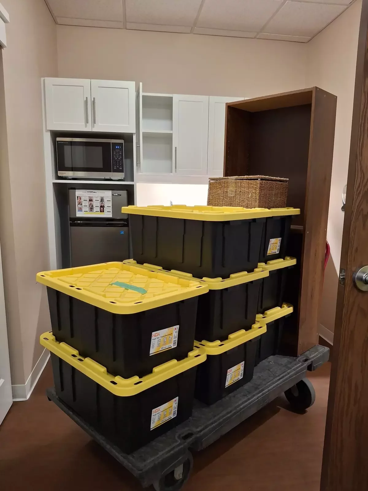 Stacked totes on a dolly in a kitchen