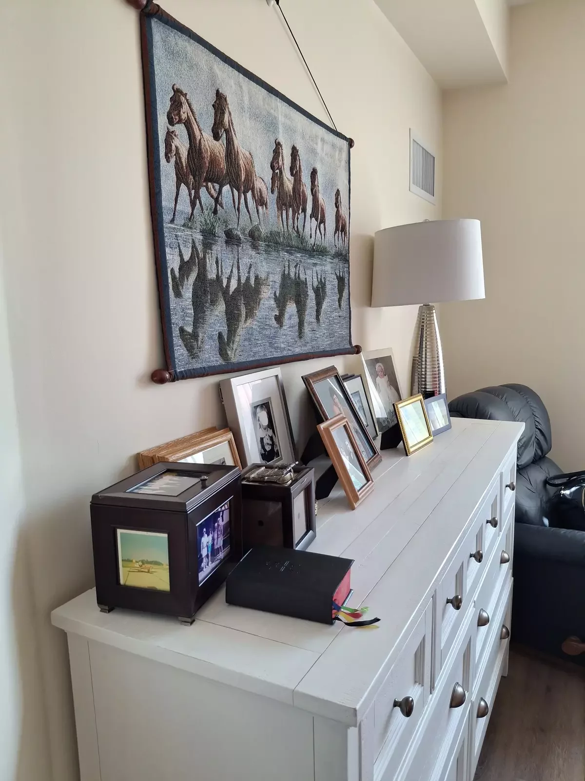 Group of picture frames on a dresser