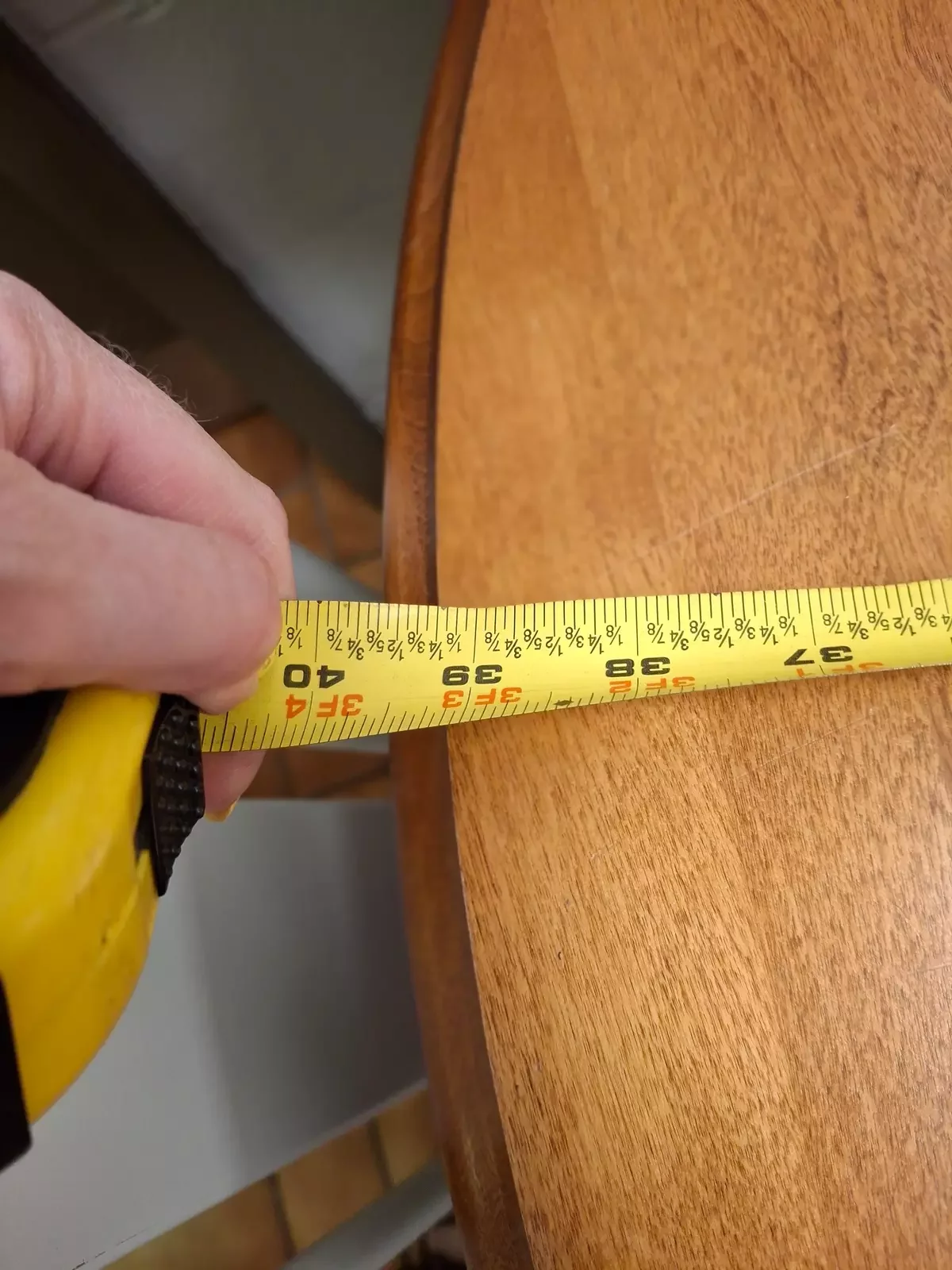 Image of someone measuring a table