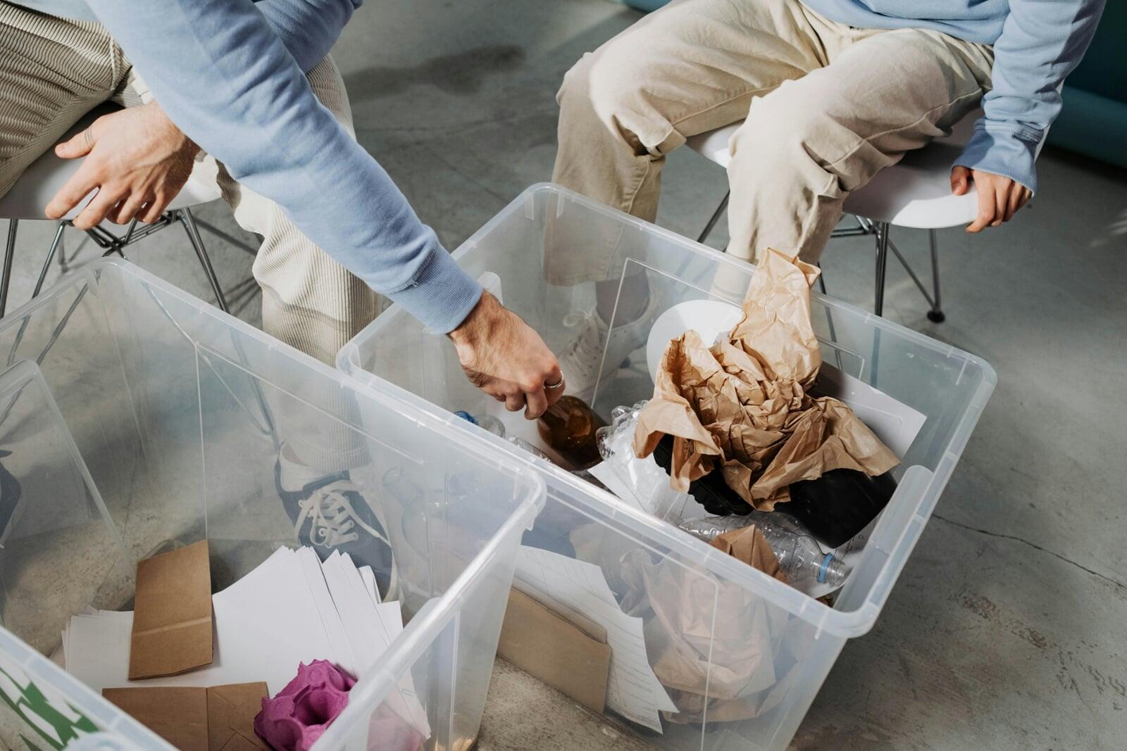 Senior mover helping senior sort clothes in totes